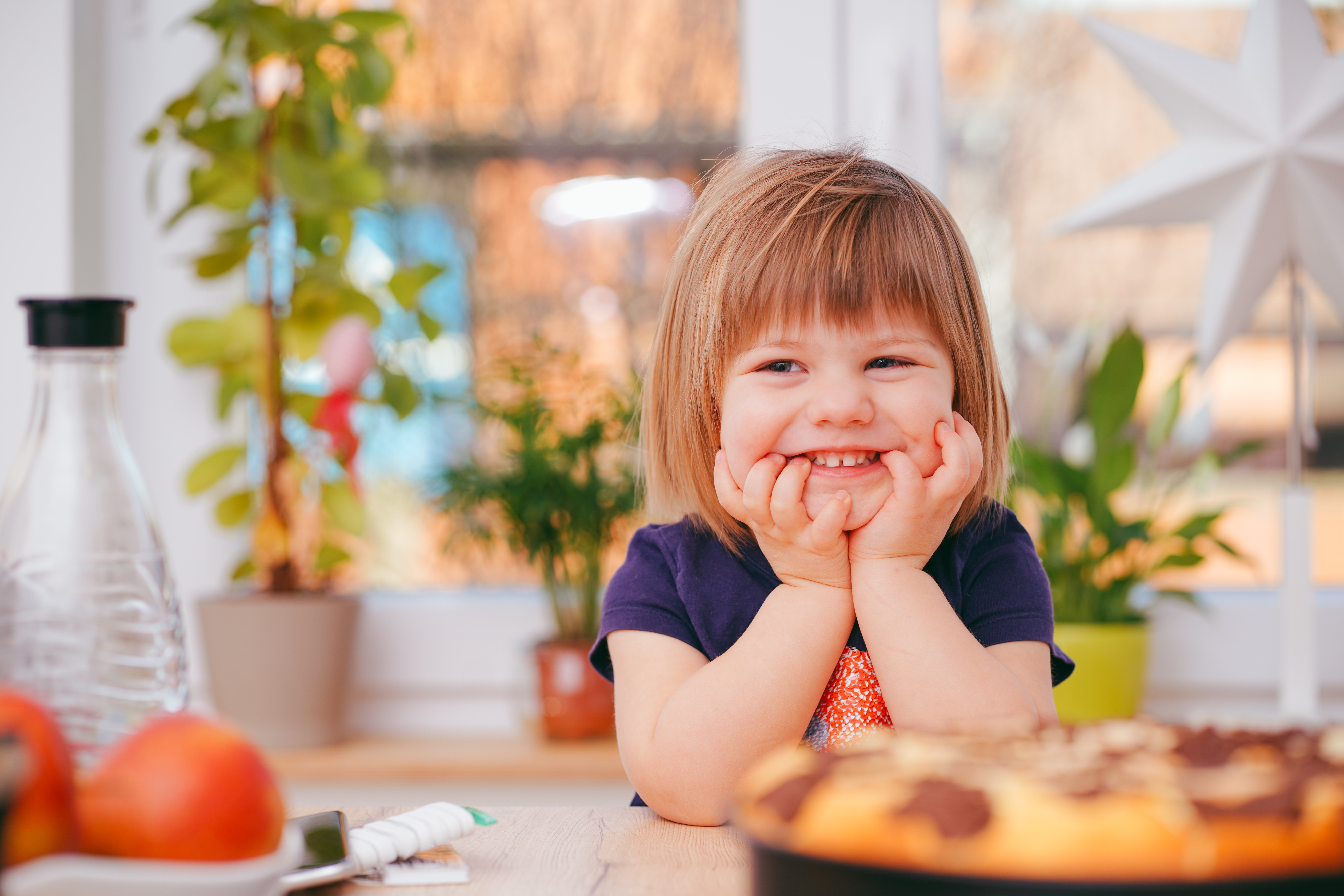 Child smiling at dinner table