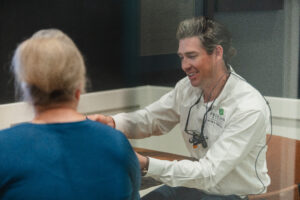 Dr. Jacob reviewing patient records with older female patient