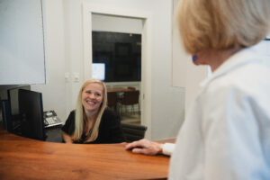 administration staff checks in patient for dental veneers